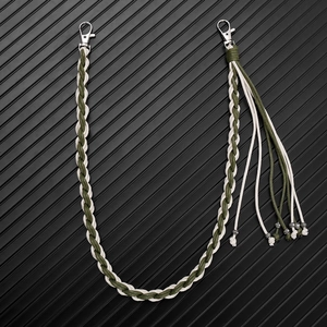 Detail of olive green woven pant chain with silver lobster clasps and tassel ornament