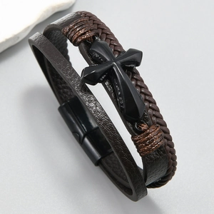 Detail of multi-layer woven brown leather bracelet with black cross and magnetic clasp