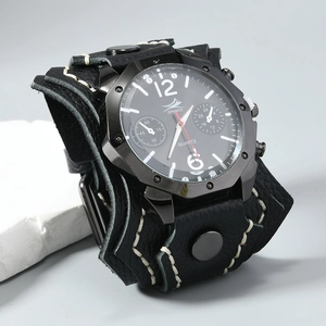 Detail of hand-stitched black leather watch band with rivets and punk style large dial