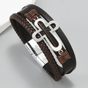 Detailed view of multilayer braided leather bracelet with silver hollow cross and magnetic clasp