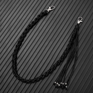 Detail of hand-woven black wax cord trouser chain with silver lobster clasps and tassels