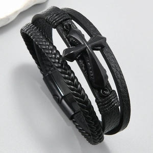 Detailed view of multilayer black braided leather bracelet with matte cross and magnetic clasp