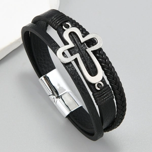 Macro shot of multi-layer braided leather bracelet with hollow cross and magnetic clasp