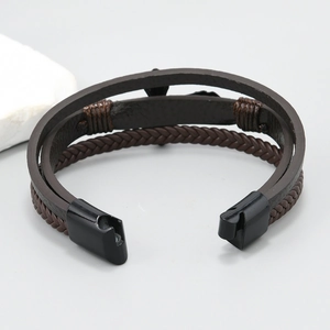 Detail view of multi-layer braided leather bracelet with black magnetic clasp mechanism