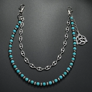 Detail of turquoise beaded waist chain with Celtic knot pendant and bean link silver chain