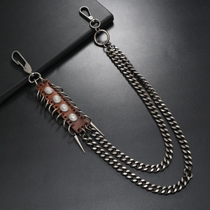 Detail of punk multi-layer metal trousers chain with leather and vintage rivets