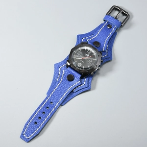 Detail of blue textured leather strap with white stitching on punk quartz watch