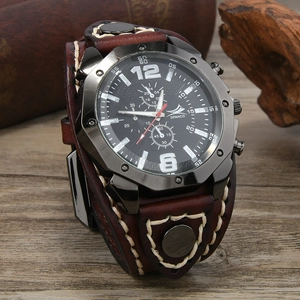 Detail of wide brown leather watch strap with retro stitching on rustic wood