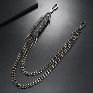 Detail view of punk multi-layer metal pants chain with black leather and silver spikes