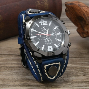Macro shot of blue wide leather watch band with white hand-stitching and black metal case