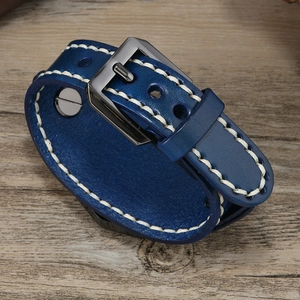Close-up of vintage blue leather bracelet with white stitching and metal buckle