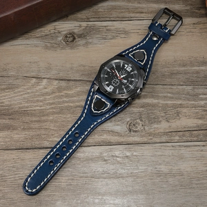 Detail of vintage blue leather watch strap with white stitching and rivets