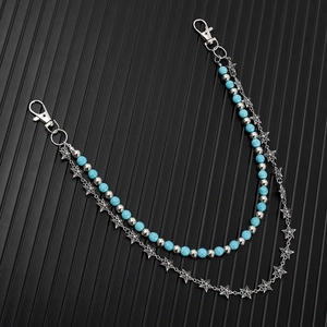 Detail of double-layer waist chain with turquoise beads and silver star pendants