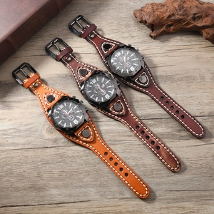 Detailed view of vintage wide leather cuff watches with thick stitching and metal rivets