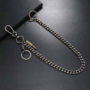 Close-up of gothic silver wallet chain with bullet and spring charms for men