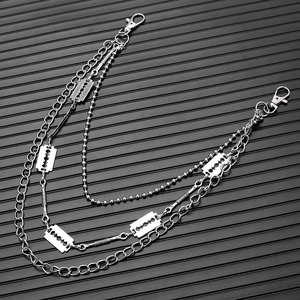 Close-up of multilayer silver metal wallet chains with rectangular blade pendants