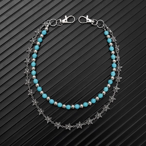 Detail of double-layer waist chain with turquoise beads and silver star link texture