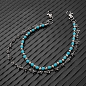 Detail of layered waist chain with carved metal stars and turquoise beads on lobster clasps