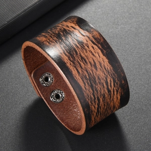Detailed view of vintage dark brown leather wristband with double silver snap buttons