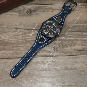 Retro punk style men's wide blue leather watch with white stitching on wood background