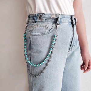 Double-layer star charm turquoise waist chain accessory shown on light blue denim jeans