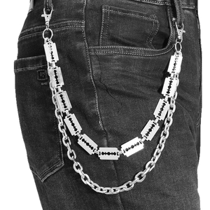 Punk style layered silver wallet chain with razor blade charms on black denim jeans