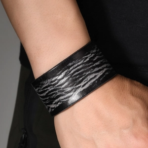 Men's retro distressed black leather bracelet with silver striped texture on wrist