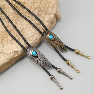 Retro feather bolo tie set with turquoise in antique silver and bronze on black braided cord