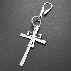 Close-up of double layered silver cross keychain with snap hook and circular ring