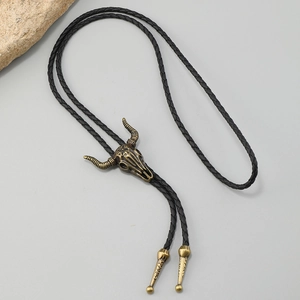 Detail of vintage zinc alloy bull skull bolo tie with black braided leather cord