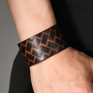 Retro wide leather bracelet for men featuring brown geometric patterns and vintage style