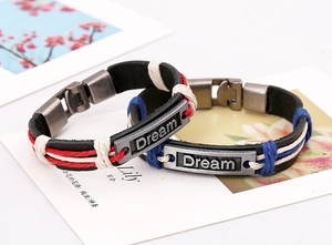 Close-up of leather braided Dream bracelets with vintage metal plates and woven cords