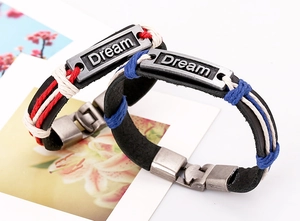 Detailed close-up of woven leather Dream bracelet with vintage alloy plate and colorful cords