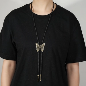 Vintage western bolo tie with bronze butterfly pendant on a black braided leather cord