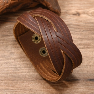 Close-up of vintage brown leather woven bracelet for men with metal snap buttons