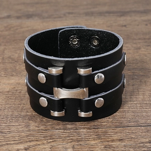 Macro detail of punk style black multi-layer leather bracelet with silver metal rivets
