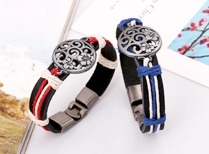 Detail of woven leather bracelets with vintage silver floral charms and metal clasps