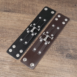 Detail view of punk style wide leather bracelets with silver rivets and metal buckles
