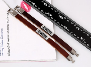 Macro shot showing retro brown leather bracelets with Best Friend engraved metal charms