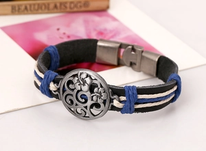 Macro detail of retro leather bracelet with silver metal floral relief and braided cords