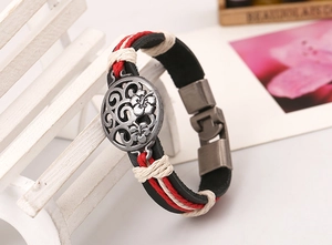 Detail of retro leather bracelet with hibiscus floral metal pendant and woven ropes