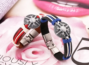 Detail of vintage braided leather bracelets featuring alloy shield charms and buckles
