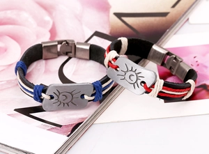 Détail de bracelets en cuir tressé avec breloques totem soleil lune et fermoirs en métal