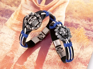 Detail of leather punk bracelets featuring skull and lion head charms with blue woven cord