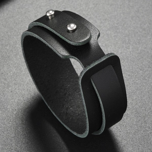 Detail view of double-wrap black leather bracelet with silver metal rivet fasteners