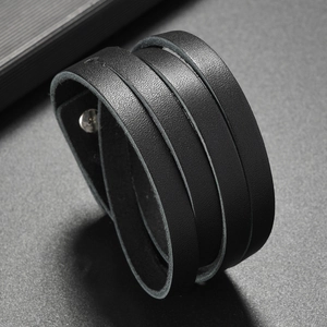 Close-up of black multi-layer leather bracelet with lychee texture and silver snap button