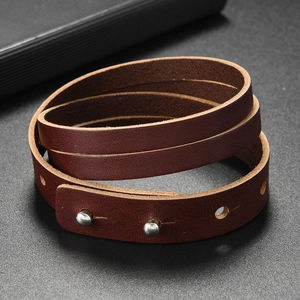 Detail of vintage brown multi-wrap leather bracelet with silver adjustable metal studs