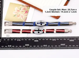 Detail view of woven leather couple bracelets with cross metal plate and buckle closure