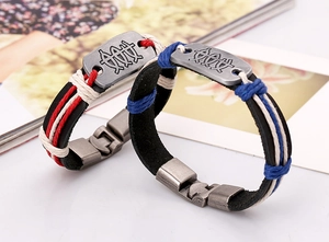 Macro detail of hand-woven leather bracelets with retro totem charms and snap closures