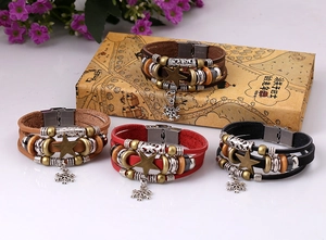 Close-up of retro punk multilayer braided leather bracelets with star and snowflake charms